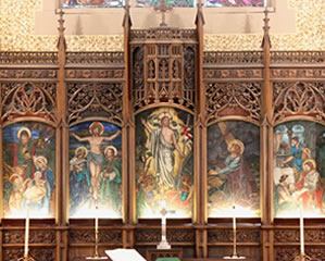 The altar and carved, painted reredos in the sanctuary